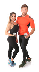 Obraz na płótnie Canvas Sporty young couple with dumbbells on white background