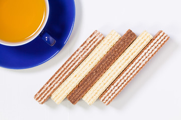 Perfect cup of tea on wooden table with sweet wafers