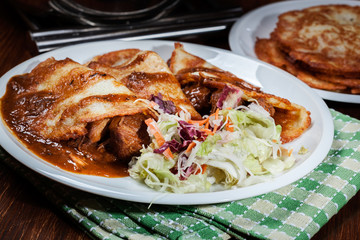 Potato pancakes with meat stew served