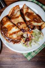 Potato pancakes with meat stew served