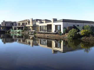 Fototapeta na wymiar House reflected in water at Century Cirty, Cape Town, South Africa