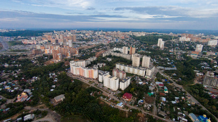 Autumn in city. Panoramic aerial view at road, forest, river.