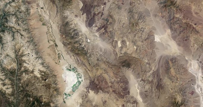 High-altitude overflight aerial of rocky, arid terrain in Mojave Desert, Arizona. Clip loops and is reversible. Elements of this image furnished by USGS/NASA Landsat