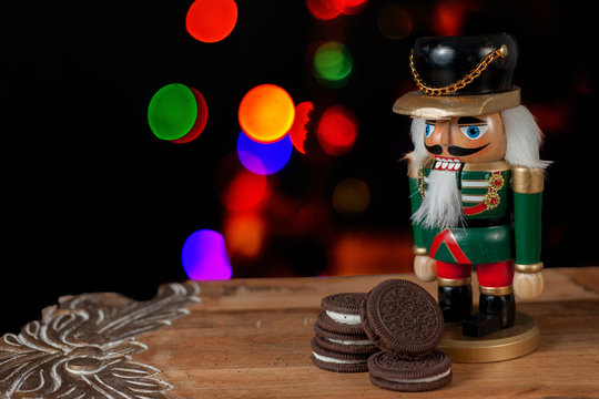 Nutcracker dressed in uniform guard the cookies for Santa Claus