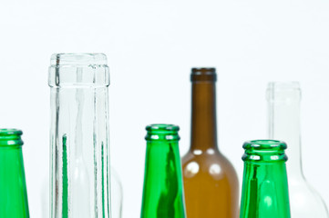 Glass bottles of mixed colors including green, clear white, brow