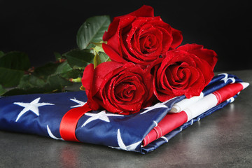 Red roses on American flag, closeup
