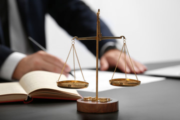 Scales of justice on table, closeup