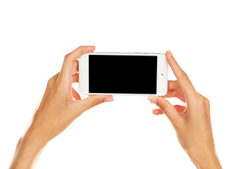 Female hands holding cellphone, isolated on white