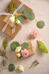 Handcrafted gift boxes with flowers on table