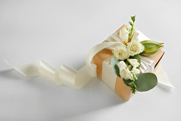 Fototapeta premium Handcrafted gift box with flowers on white background
