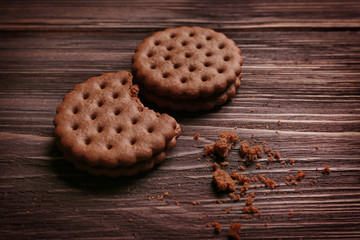 Tasty cookies with crumbs on wooden background