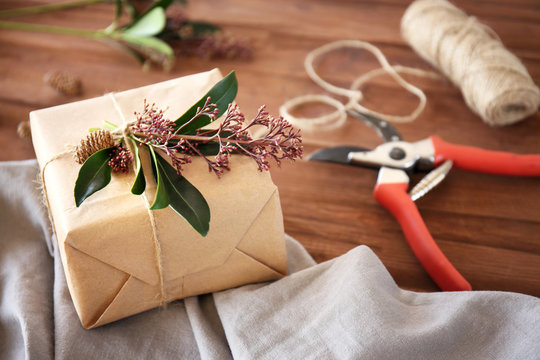 Handcrafted gift box with flowers on wooden table