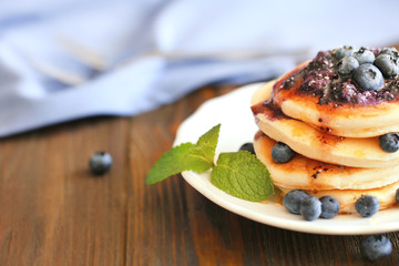 Tasty pancakes with blueberry on plate
