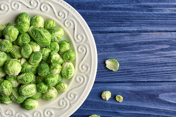 Plate with brussels sprouts on wooden table