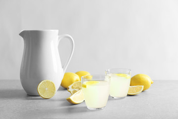 Glasses of refreshing lemonade on table