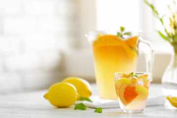 Citrus cocktail on table on blurred window background