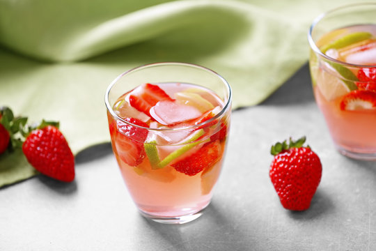 Two glasses of fresh strawberry cocktail on light background