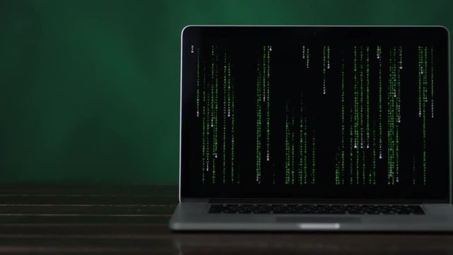 vertical binary code at laptop standing at the desk