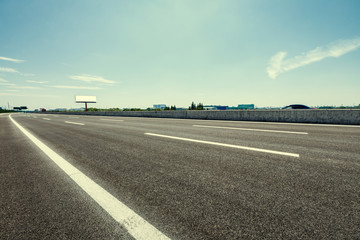 Fototapeta premium Asphalt road under the blue sky
