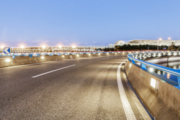 asphalt road before the airport at dusk