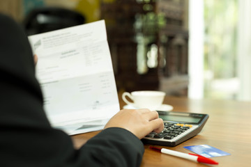 Business woman doing financial calculating bills from credit car