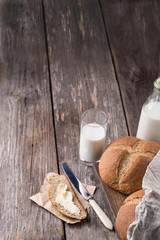 Rustic breakfast with wholegrain bread, milk and butter