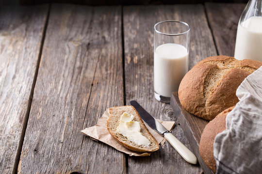 Rustic breakfast with wholegrain bread, milk and butter