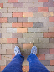Feet on the cobblestone.