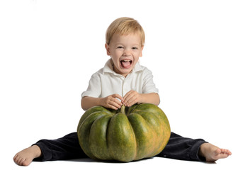 Fototapeta premium Cute boy sitting with pumpkin isolated on white background