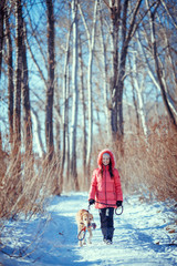 Fototapeta na wymiar Woman with a dog Labrador playing in winter outdoors