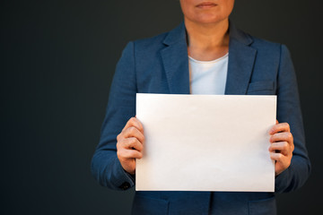 Business woman holding blank document paper