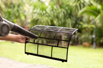 Technician man dry up and dust cleaning air Conditioner filter w