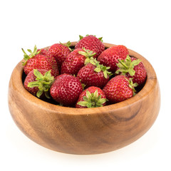 Strawberries in a wooden bowl isolated on white background.