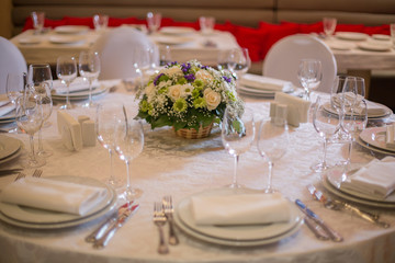 Round table with Italian food, white tablecloth candelabrum