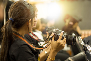 woman hand holding camera in workshop room