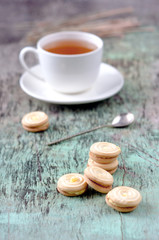 A cup of hot herbal tea and cookies on the old wooden background. Cup of tea herbal tea hot drink Baking Cookies Vintage texture background