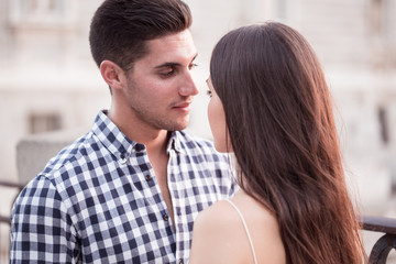 Young and beautiful couple kissing at sunset