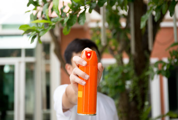 Young boy hand holding insect spray