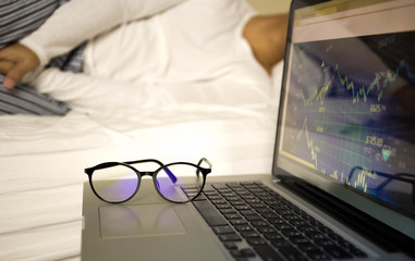 Conceptual focus on glasses businessman working on laptop sleepi