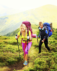 Man tourist walking the mountains with a backpack.