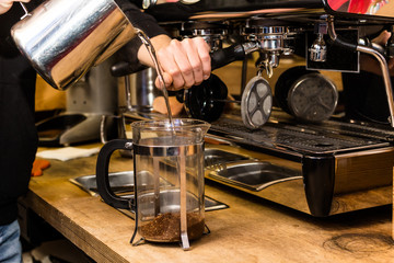 Barista making non traditional coffee in french press