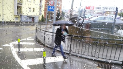 Man with umbrella walking under the rain