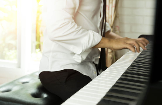 Selected focus on piano keys man playing the piano