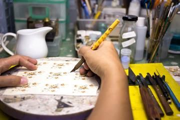 Male hand cutting paper with a stationery knife