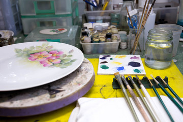 Selected focus on paintbrushes and color on palette with paint t