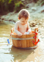 The small boy sits in the tub