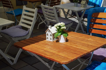 Street view of a coffee terrace with tables and chairs