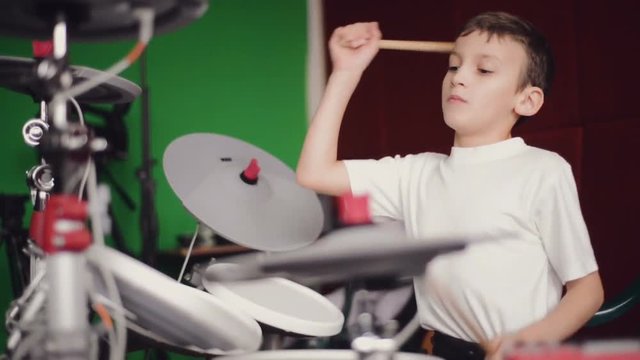 little boy playing electronic drums slow motion