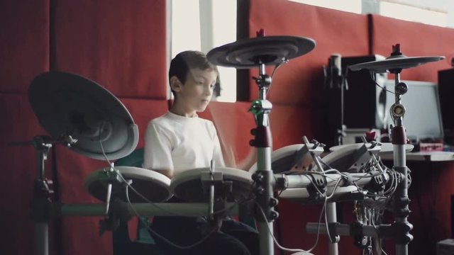 little boy playing electronic drums slow motion