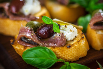 Tasty bruschetta with anchovy, caper, olive oil ...